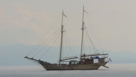 A-beautifully-crafted-sailing-ship-anchored-near-Kir-Island-in-Raja-Ampat,-Indonesia