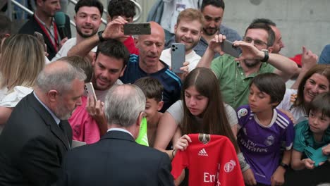 Real-Madrid-president,-Florentino-Perez,-greets-fans-and-signs-autographs-during-the-celebration-of-their-15th-UEFA-Champions-League-cup-title-in-Madrid,-Spain