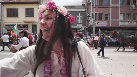 Bulgarian-folk-costumed-girls-throw-rose-petals-at-cheering-festival-crowds