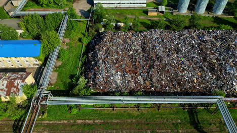 Aerial-metal-scrapyard-aluminium-copper-recycling-piles-of-rusty-iron