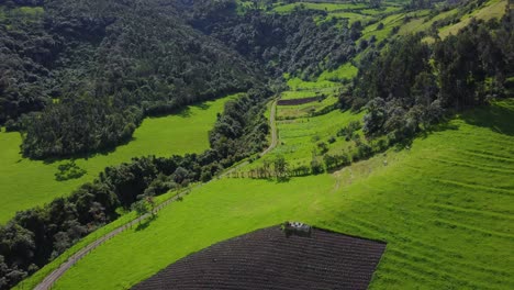 Aerial-Drone-Flyover-Push-Above-Foothills-of-the-Pasochoa-volcano,-Puichig-neighborhood,-showing-the-Machachi-valley,-Cantón-Mejía,-Pichincha-Province,-Ecuador