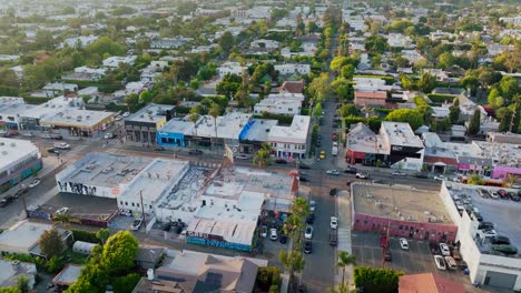 Birdseye-View-of-Melrose-Avenue-Shopping-District-in-West-Hollywood-on-Sunny-Day,-Traffic-and-Rooftops-Below