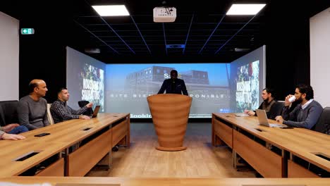 slow-dolly-shot-of-a-CEO-speaking-in-the-board-room-about-a-new-bowling-alley