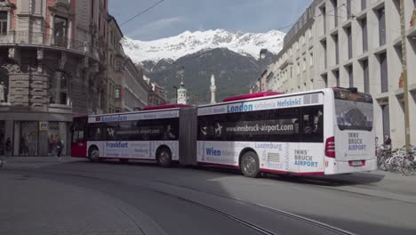 A-public-transport-bus-drives-past-the-town-square,-junction-Anichstrasse-street-and-Maria-Theresien-Strasse-street