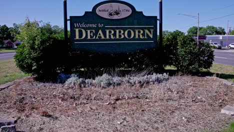 Welcome-to-Dearborn,-Michigan-sign-with-video-tilting-up-close-up