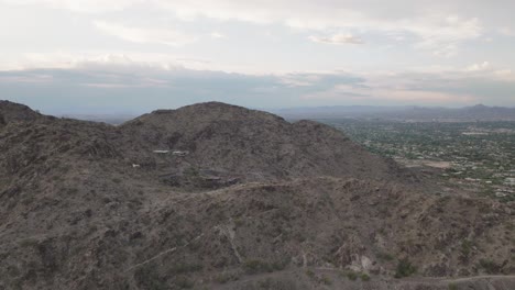 Drone-shot-flying-over-mummy-mountain-revealing-the-suburban-area-near-Phoenix,-Arizona-in-USA