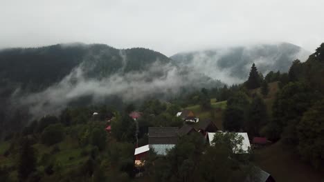 Foggy-Misty-Mountain-with-Cabins-in-the-mountains-of-Matisesti,-Alba,-Romania