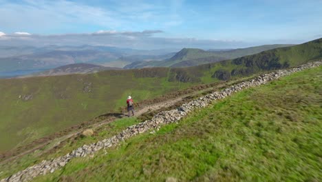 Mountain-walker-stopped-on-mountainside-path