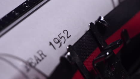 Year-1952,-Typing-on-White-Paper-in-Vintage-Typewriter,-Close-Up