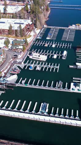 Vertical-Aerial-View,-Lake-Tahoe-Marina-and-Waterfront-Buildings-on-Sunny-Winter-Day,-California-USA,-Drone-Shot