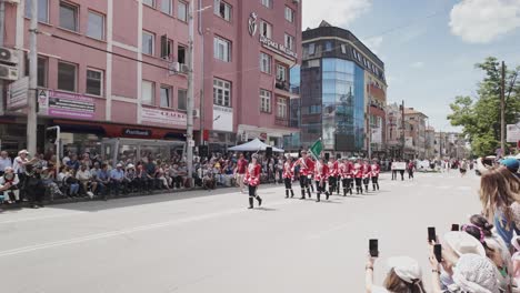 Soldiers-dressed-in-red-tunics-marchin-Bulgarian-Rose-fesival-parade