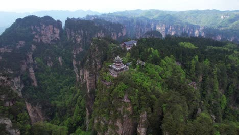 Aerial-circling-Liuqi-Pavilion-revealing-cable-car-arriving-Huangshi-Village,-China