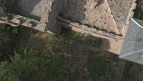 Topdwon-shot-close-to-the-roofs-of-Perafita-Castle-in-Catalonia,-Spain