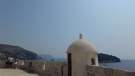 Visitors-and-travelers-explore-the-city-walls-of-Dubrovnik,-Croatia,-on-a-sunny-day