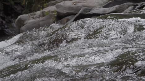 Close-up-of-rushing-water-at-Goa-Rang-Reng-Waterfall-in-Bali