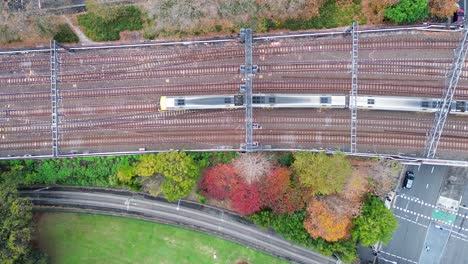 Landscape-bird's-eye-view-of-train-travelling-along-railroad-tracks-commute-carriages-into-Central-Station-platform-Sydney-Haymarket-Australia-transport