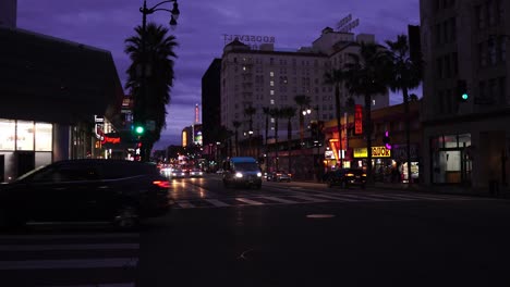 Night-Traffic-on-Hollywood-Boulevard,-Lights,-Vehicles-and-Buildings,-Los-Angeles-CA-USA