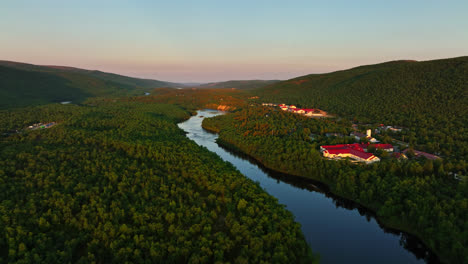 Drone-rising-along-the-Stuorraluoppal-river,-summer-sunset-in-Utsjoki,-Finland