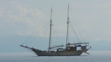 two-masted-yacht-anchored-near-Kri-Island,-Raja-Ampat,-Indonesia