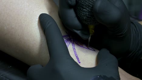 Every-time-after-tattooing-a-line,-the-excess-ink-is-dabbed-away