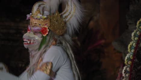 Close-up-of-a-performer-in-traditional-Balinese-dance,-featuring-beautifully-crafted-mask-and-elaborate-costume