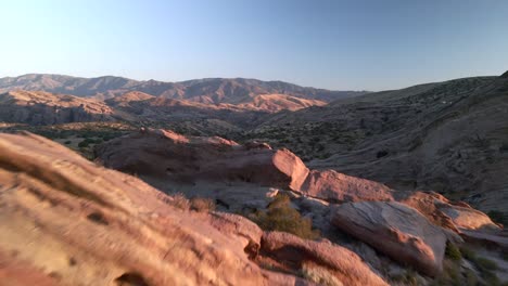 Drohne-Fliegt-Durch-Eine-Lücke-In-Den-Felsen-Des-Naturparks-Vasquez,-Sonnenuntergang-In-Den-USA