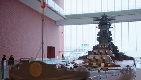 Slow-motion-establishing-shot-of-worlds-largest-battleship-at-Kure-city,-home-of-Japanese-naval-bases