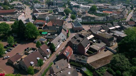 Aerial-footage-of-Budel-centre-in-Cranendonck-village,-showcasing-charming-streets,-historical-buildings,-and-lush-greenery