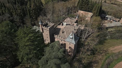 Aerial-circle-view-of-Perafita-Castle-in-Catalonia,-Spain,-Daylight