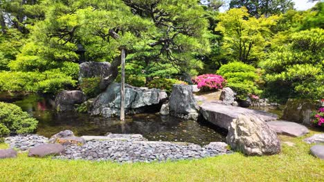 Japanese-garden-in-Kyoto,-Japan,-with-flowers,-stones,-water,-and-trees