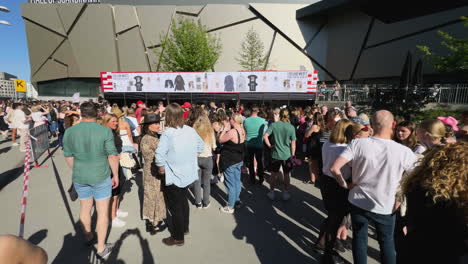 Taylor-Swift-Fans,-also-known-as-Swifties,-Wait-in-Crowded-Line-for-Merchandise-outside-the-Eras-Tour-in-Stockholm,-Sweden