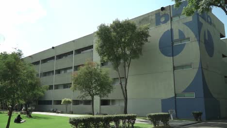 Student-walks-outside-Building-A-at-Universidad-Autonoma-Metropolitana-campus-in-Xochimilco,-Mexico