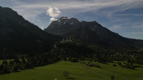 Drone-Rising-High-Towards-Historical-Neuschwanstein-Castle-In-Schwangau-Bayern,-Germany