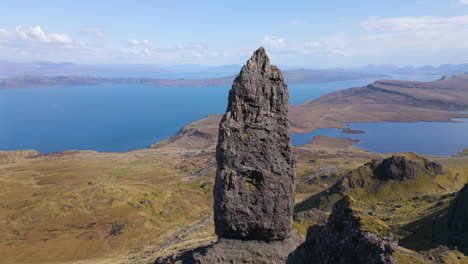 Aerial-circling-The-Old-Man-of-Storr,-Sound-of-Raasay-in-background