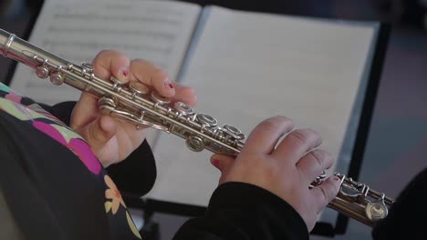 Close-up-of-a-flute-player's-hands-during-a-performance