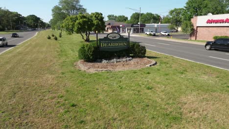 Welcome-to-Dearborn,-Michigan-sign-with-drone-video-moving-in