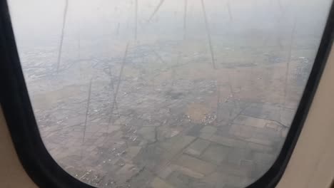 View-of-housing-shoot-behind-airplane-window