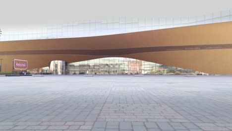 Low-aerial-approach-toward-modern-facade-of-Helsinki-Central-Library-Oodi