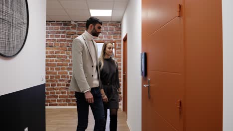 Slow-motion-shot-of-a-couple-using-a-digital-keypad-within-an-office