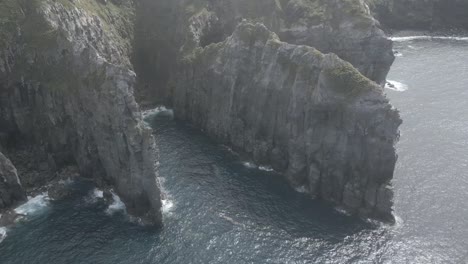 Rocky-formations-along-cliffs-of-Ponta-do-Cintrao,-Atlantic-ocean-in-Azores-archipelago,-Portugal