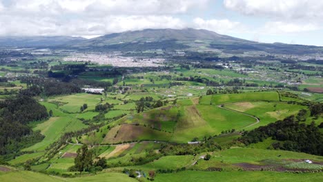 Aerial-Drone-Push-Over-Foothills-And-Valley-below-Pasochoa-volcano,-Puichig,-Machachi-valley,-Cantón-Mejía,-Pichincha-Province,-Ecuador