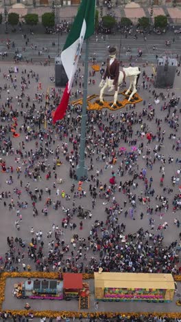 Aerial-view-of-giant-Day-of-the-Dead-skeleton-in-Mexico-City's-historic-center,-vertical-mode