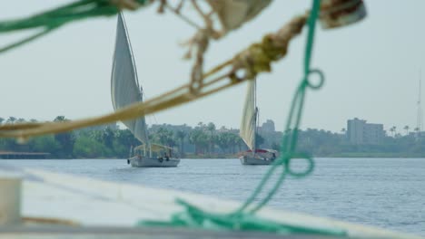 Sailboat-deck-with-rigging-and-knots,-other-sea-yachts-sailing-in-view