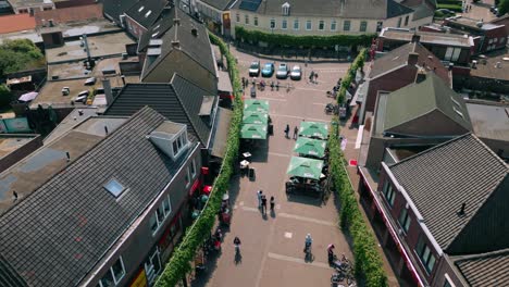 Aerial-footage-of-Markt-central-Budel-shopping-street-with-people-and-shops-visible