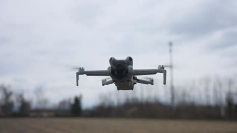 DJI-Mini-Drone-Hovering-In-Air-In-Field