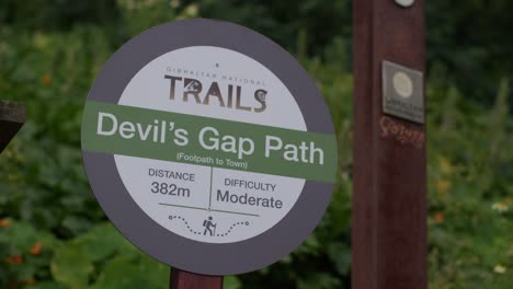 Closeup-shot-of-a-board-showing-Devils-Gap-Path-in-Gibraltar,-England