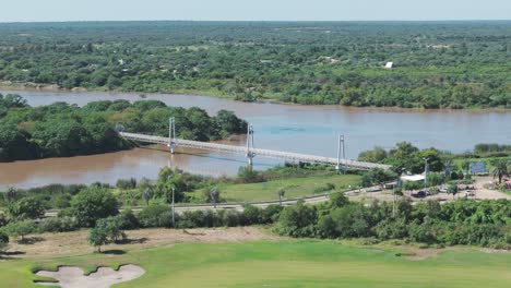 A-beautiful-suspension-bridge-in-Termas-de-Río-Hondo,-Argentina,-showcasing-architectural-elegance-against-scenic-surroundings