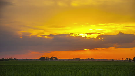 Time-lapse-sunset-moving-clouds-and-sun-beautiful-field-landscape-golden-sky