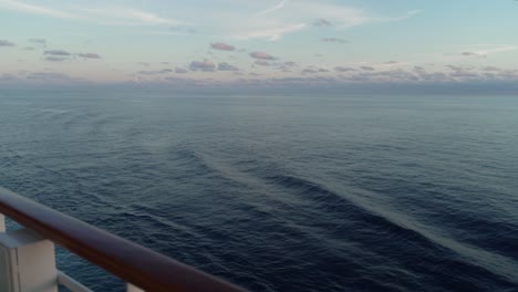 Endless-Oceanic-Vista:-On-Board-View-of-the-Boundless-Sea-from-a-Cruise-Ship,-Framed-by-a-Sturdy-Wooden-Hand-Railing