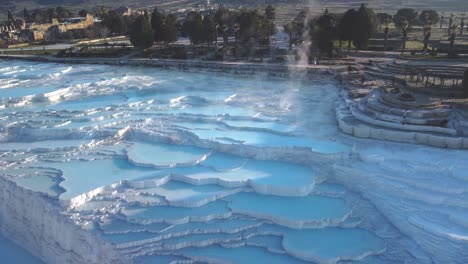 Steamy-blue-hot-springs,-mineral-waters,-forming-travertine-limestone-mineral-deposit-formations